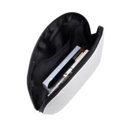 Open white zippered beauty pouch with black lining, containing professional lash and beauty tools including a brush, pen and boxed products.