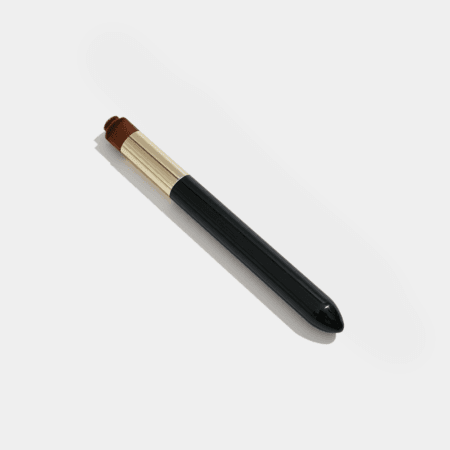 Professional lash pore cleansing brush with soft brown bristles, gold ferrule and black handle for cleaning eyelashes before treatments.