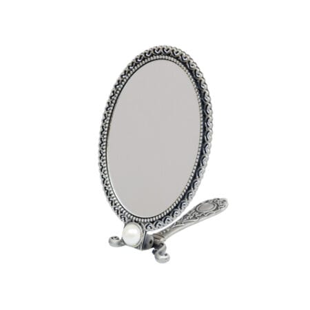 MIRROR_3 Ornate oval silver tabletop mirror with a decorative vintage-style frame and folding stand on a white background.