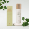 Pure Makeup Remover 2 BL Lashes All-in-One Pure Makeup Remover bottle with matching packaging, displayed on a light stone surface with green leaves.