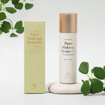 Pure Makeup Remover 2 BL Lashes All-in-One Pure Makeup Remover bottle with matching packaging, displayed on a light stone surface with green leaves.