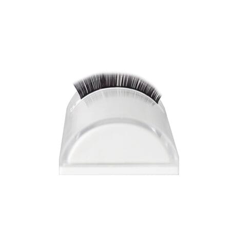 half-moon-4 Transparent half-moon lash holder with a curved surface displaying a strip of black eyelash extensions.