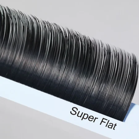 Close-up of black Super Flat eyelash extensions arranged on a white lash tray.